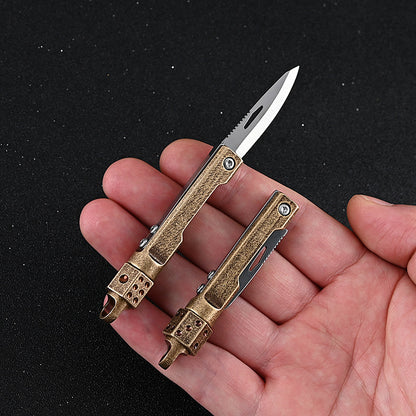 MASALONG MA-TY-041 Cuchillo plegable giratorio de latón con forma de dado, juguete de descompresión afilado, portátil, sin embalaje, caja abierta, mini cuchillo, llavero colgante