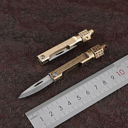 MASALONG MA-TY-041 Cuchillo plegable giratorio de latón con forma de dado, juguete de descompresión afilado, portátil, sin embalaje, caja abierta, mini cuchillo, llavero colgante